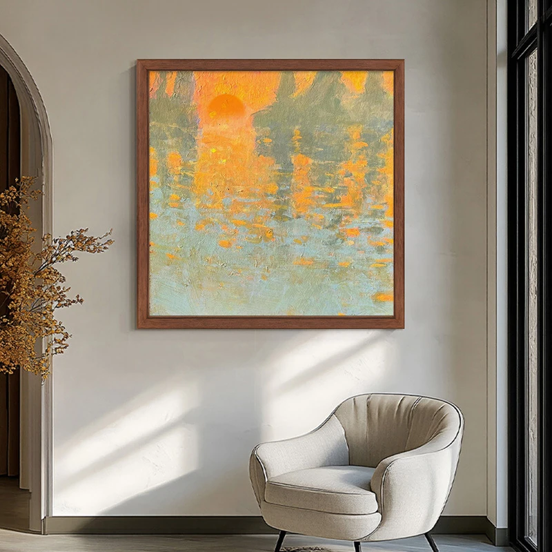 Square sunrise landscape artwork beside a reading chair